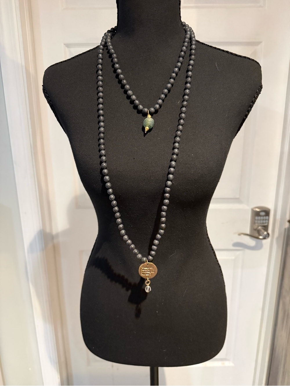 Layered Matte Black Bead Necklace with Gold Medallion and Green Accent
